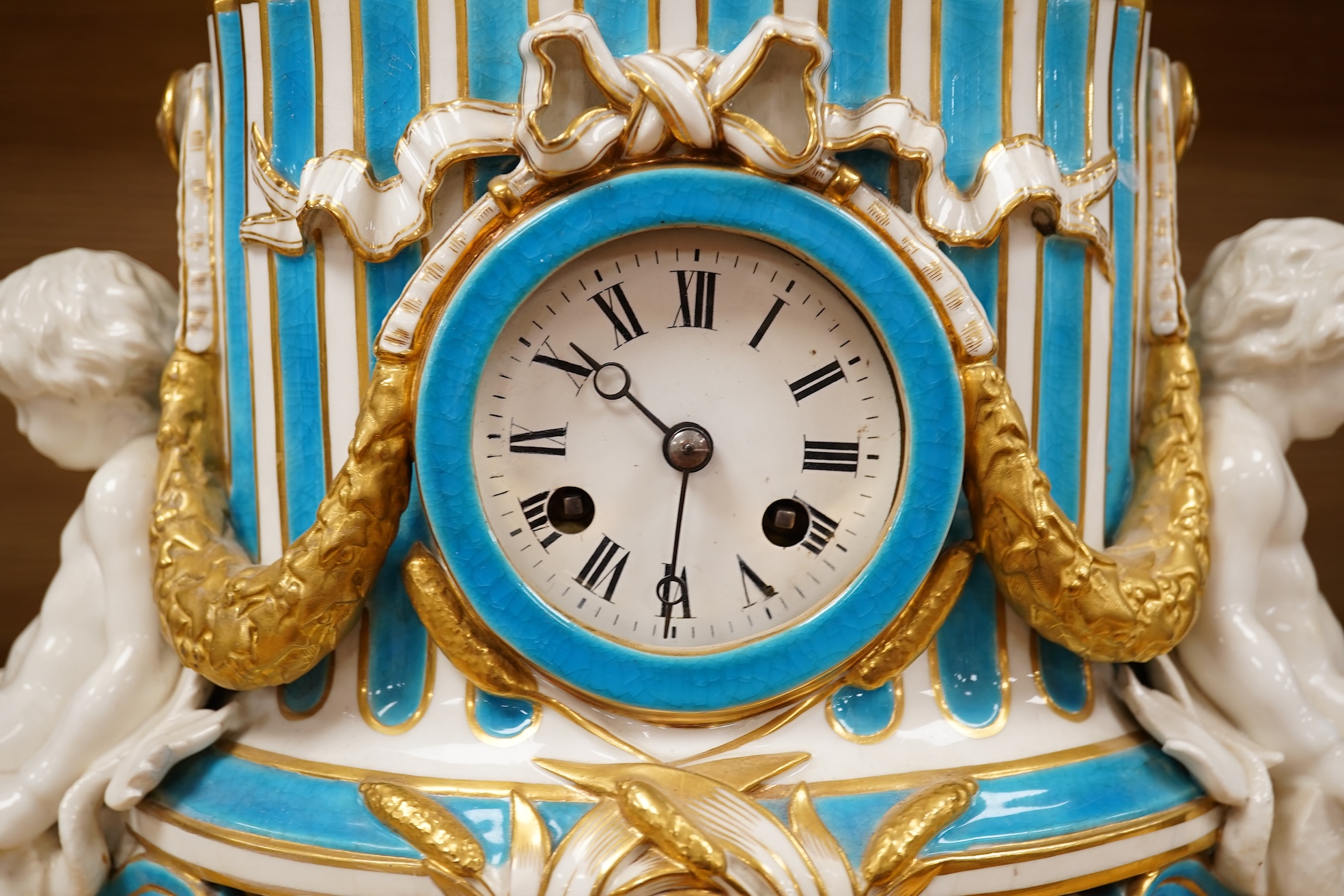 A 19th-century Sevres style porcelain mantel clock, 29cm tall